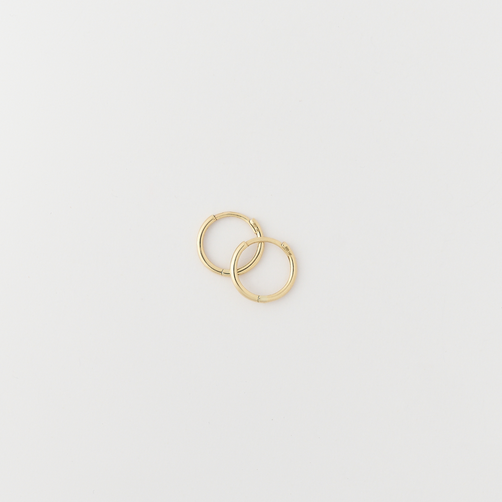 Classic gold huggie earrings with hinged click closure