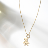 Zaerine 14k yellow gold belcher chain paired with the Orso Oro pendant, featuring a movable teddy bear design with heart details.