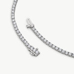 Round diamonds in polished, rounded gold tennis bracelet settings