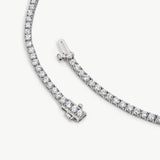 Round diamonds in polished, rounded gold tennis bracelet settings
