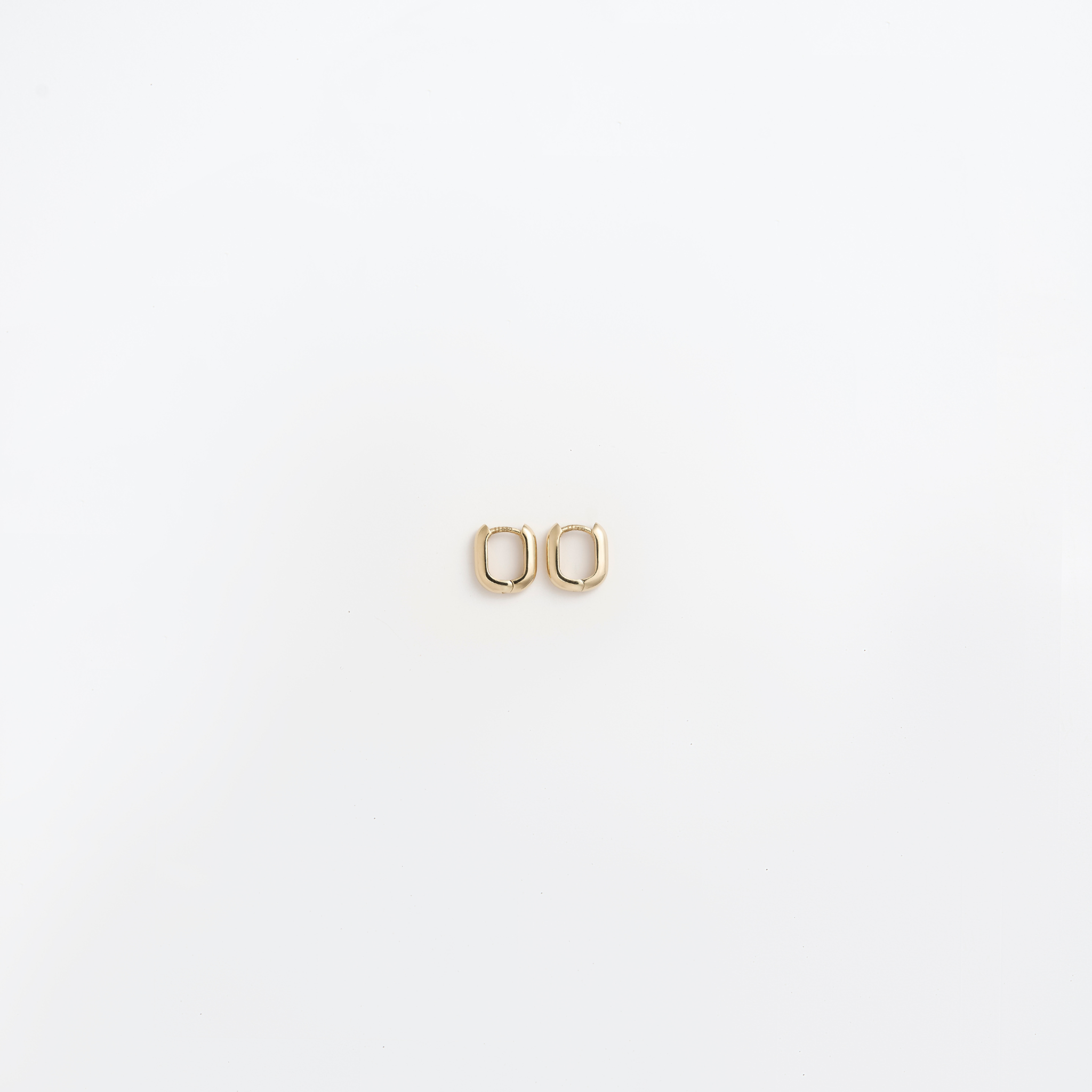 Close-up of the Small Leanea earrings in 14k yellow gold, versatile for everyday wear or stacking with the Large Leanea.