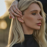 Small Leanea earrings handcrafted in 14k yellow gold with a sleek, curved design—versatile for everyday wear or stacking with the Large Leanea.