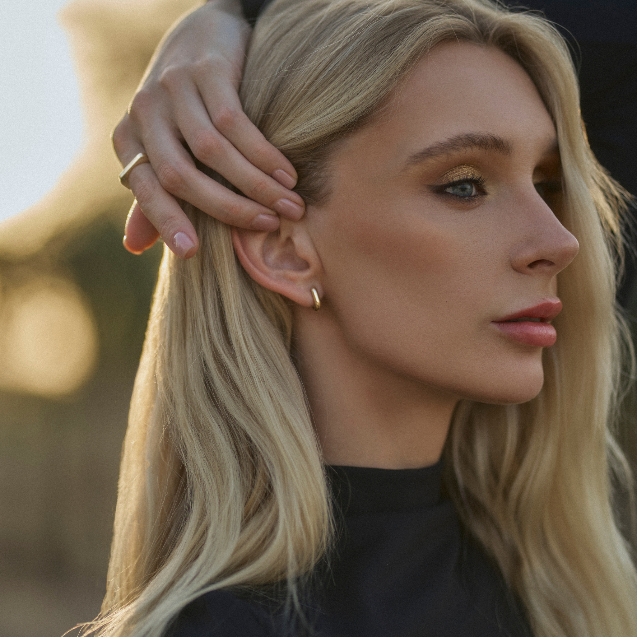 Small Leanea earrings handcrafted in 14k yellow gold with a sleek, curved design—versatile for everyday wear or stacking with the Large Leanea.