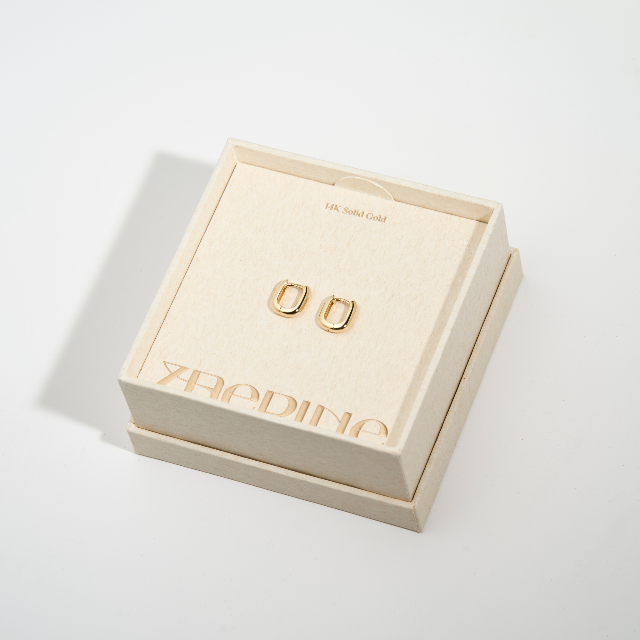 Small Leanea earrings in 14k gold, elegantly placed inside the Zaerine jewelry box—a fine jewelry piece crafted for timeless wear.